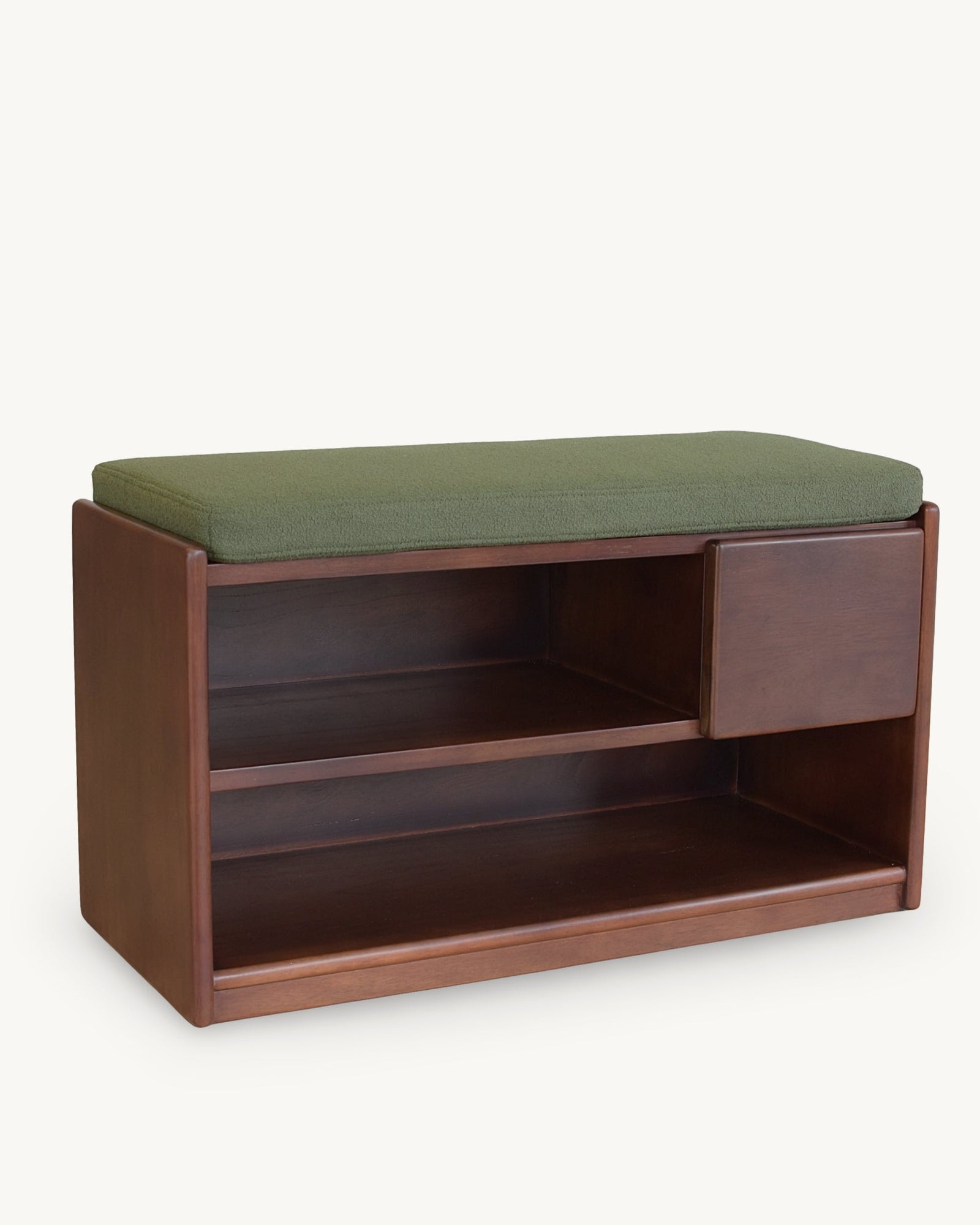 A modern wooden bench with a green upholstered cushion on top, featuring a single side drawer and two open storage shelves, shown against a plain off-white background.